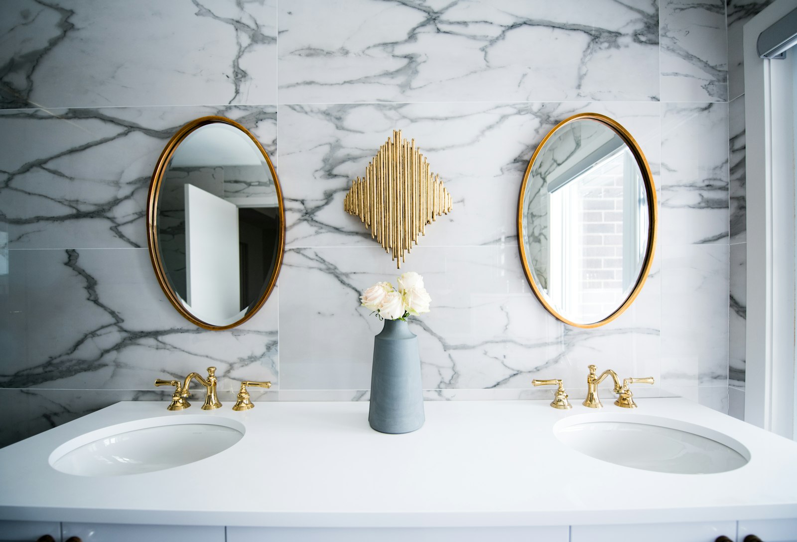Renovated marble bathroom with brass plumbing fixtures